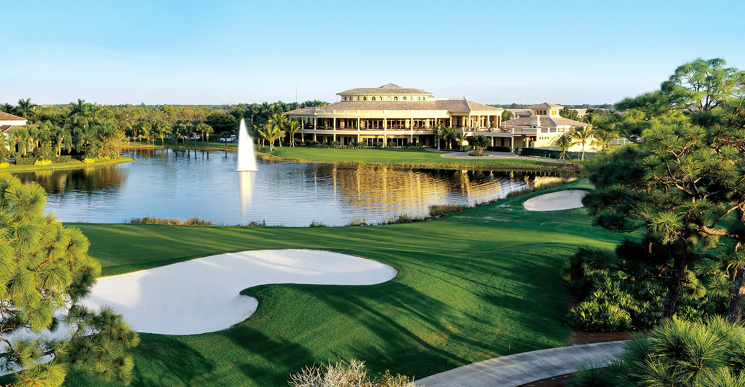 Aerial view of a coastal Bonita Springs and Estero neighborhood with golf course and water fixture